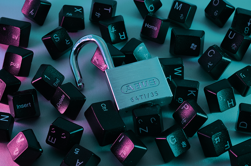 Open padlock on a pile of scattered keyboard keys