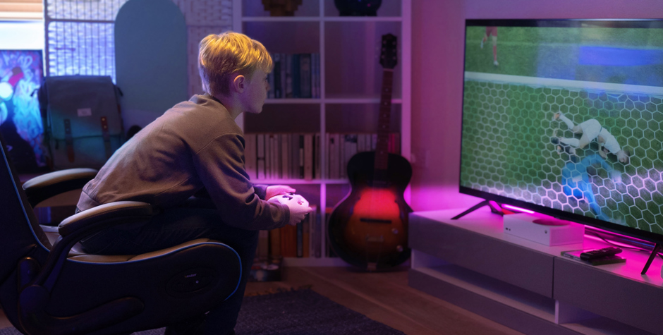 Kid on Xbox Playing Football Game with Pink Valore