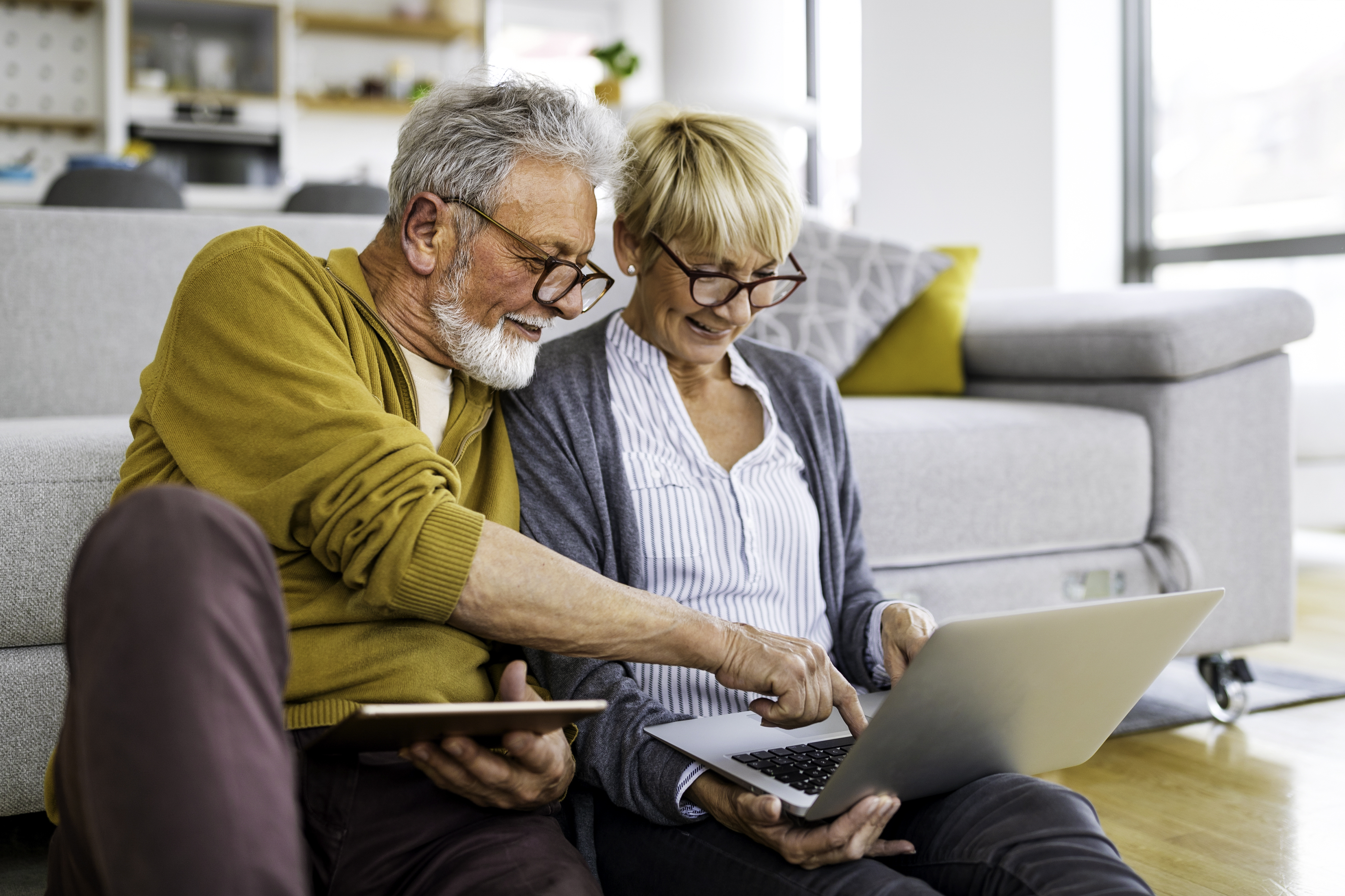 older couple pointing at a laptop screen