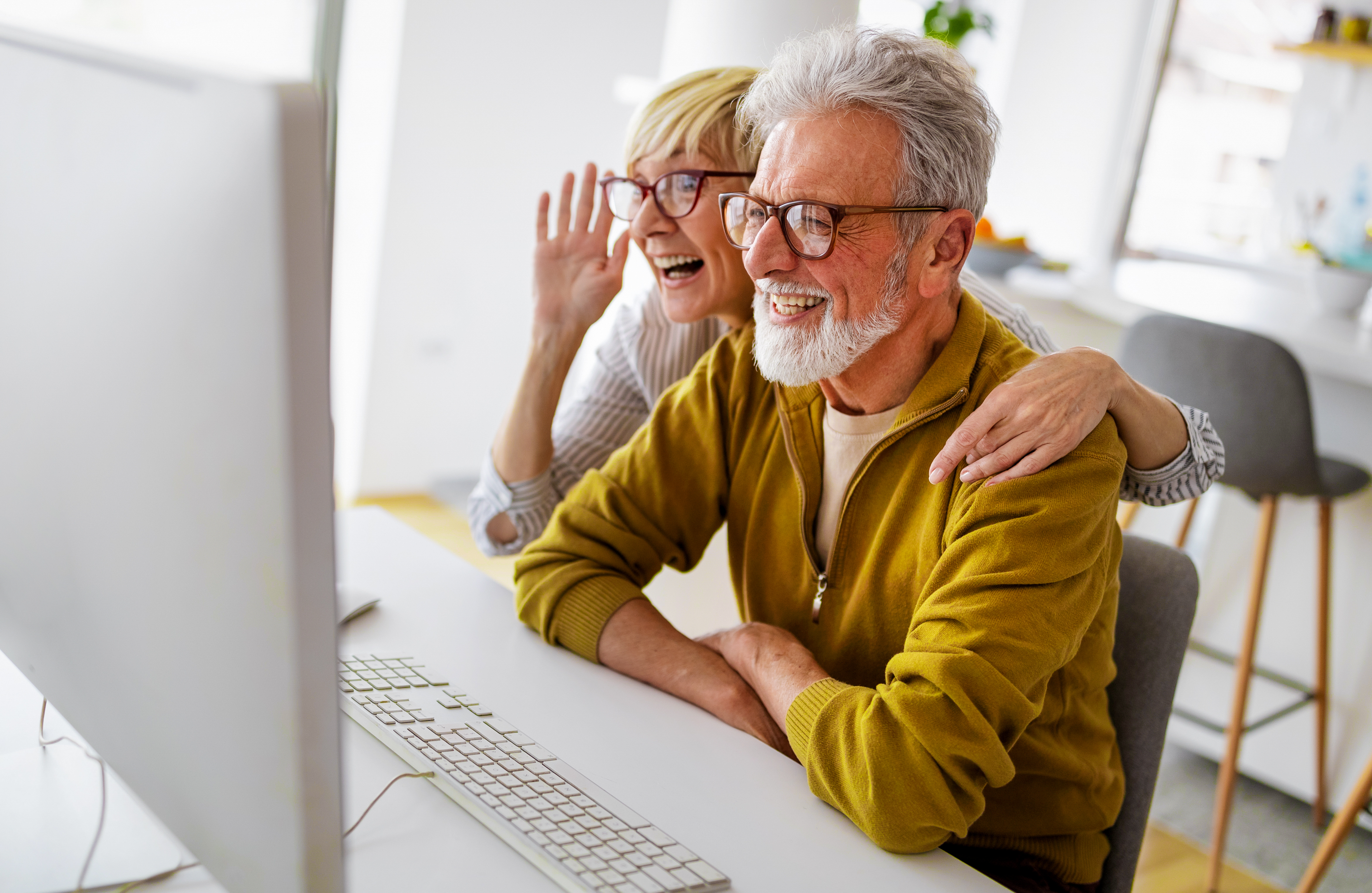 couple smiling at a computer screen