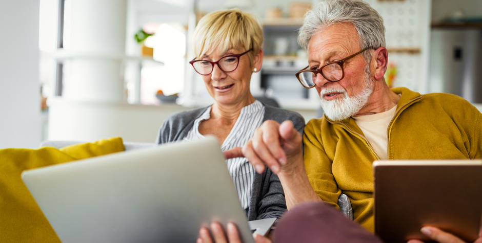 older couple pointed at a laptop screen