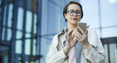 Shutter Stock Lady on Phone in Front of Glass Building